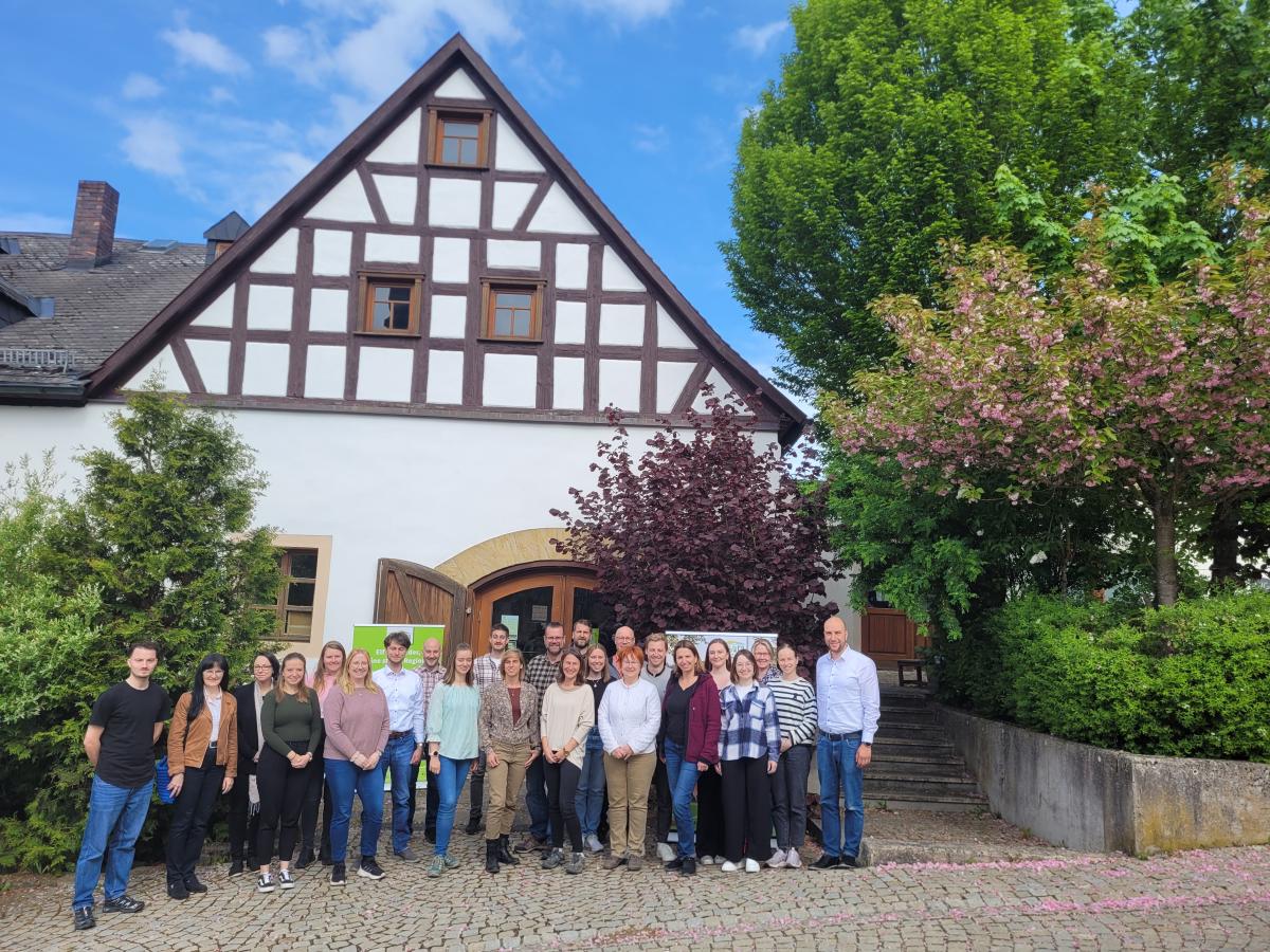 Eine Gruppe von Personen steht vor einem Haus